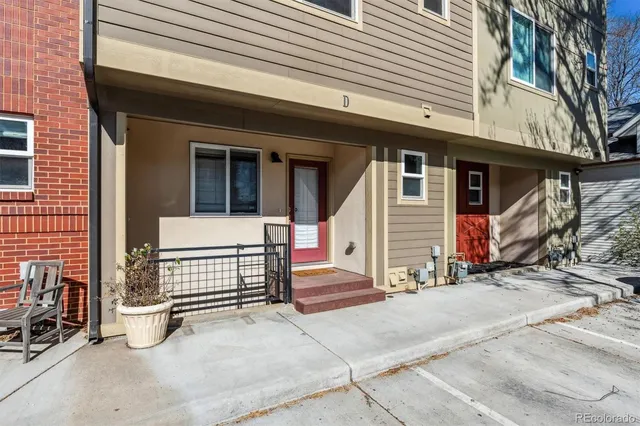 a view of a house with a yard and wooden fence