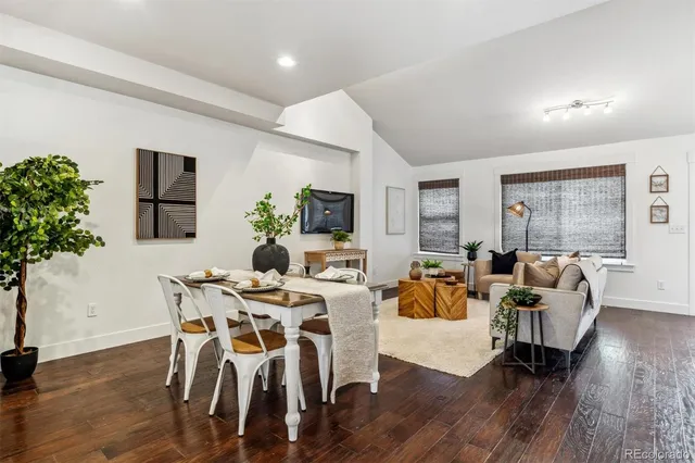 a living room with furniture dining room and wooden floor