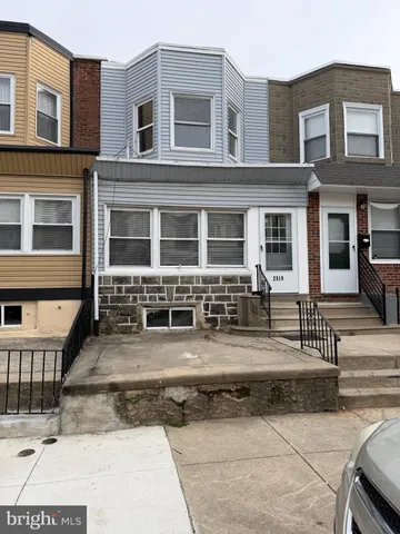 a front view of a house with stairs