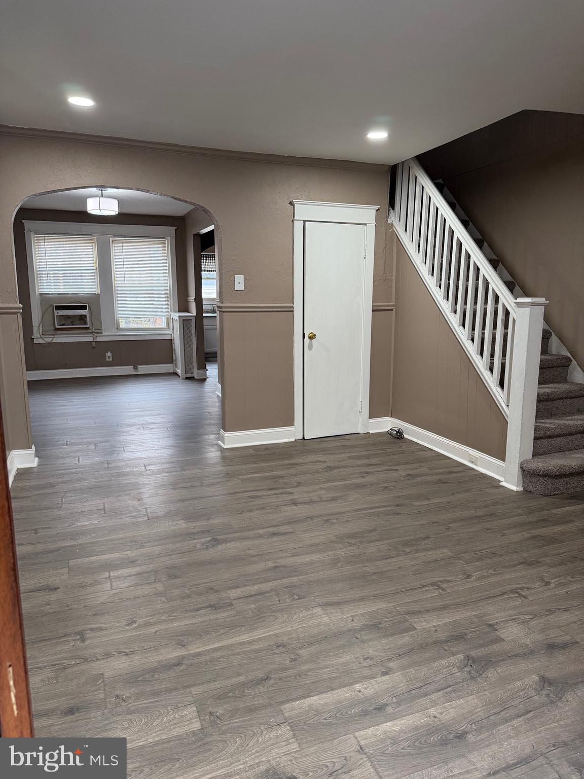 2519 Hobson Street Philadelphia, PA 19142 - Photo 6 of 8 a view of an empty room with wooden floor and staircase