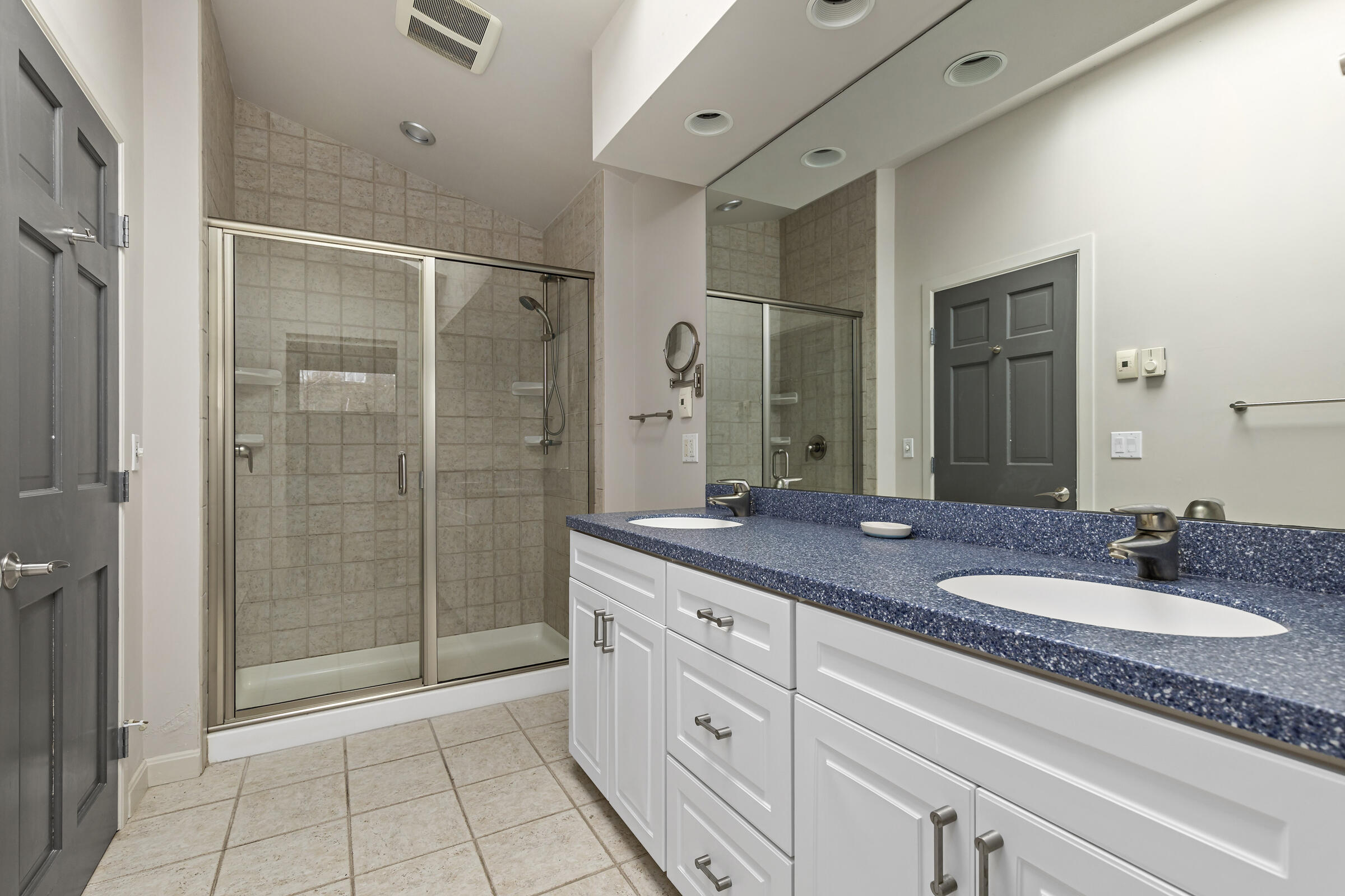 46 Twine Field Road Truro, MA 02666 - Photo 23 of 38 a spacious bathroom with a granite countertop sink a mirror and a shower