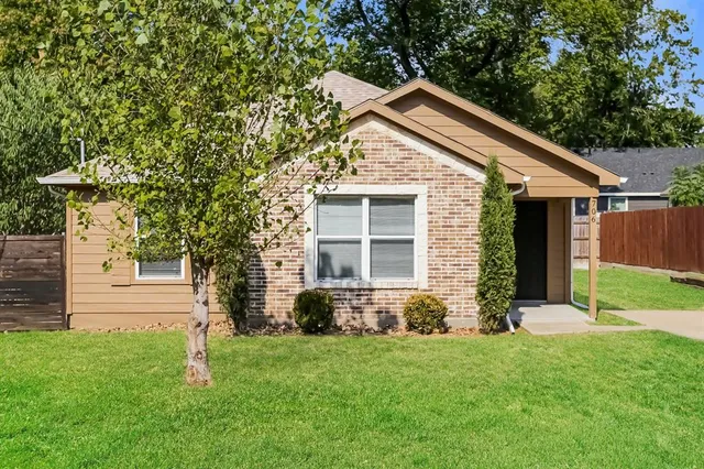 a front view of house with yard and green space