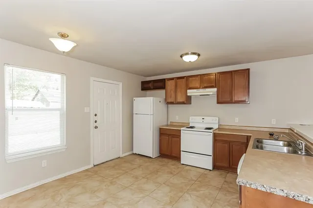 a view of a kitchen with a sink cabinets and a window