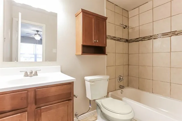a bathroom with a sink toilet vanity and shower