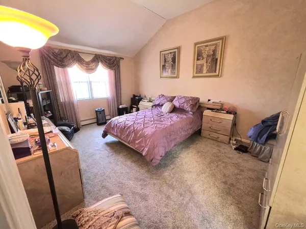 a bedroom with bed and a window