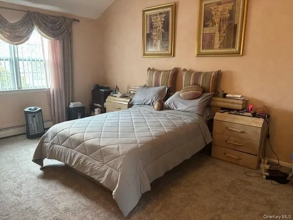 a bedroom with bed and window