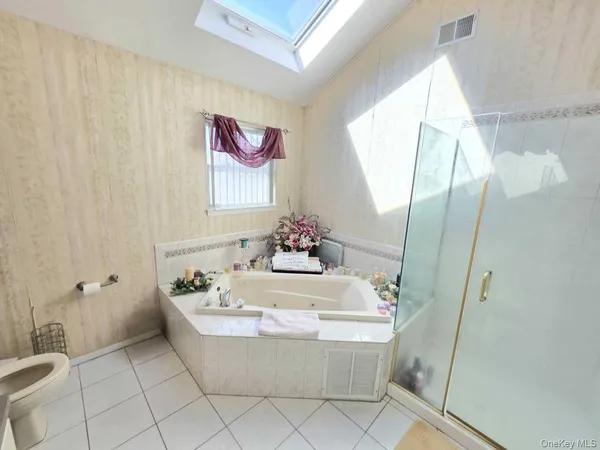 a spacious bathroom with a bathtub and sink