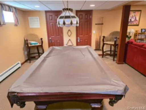 a spacious bedroom with a bed and dresser with mirror