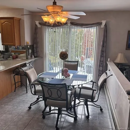a view of a dining room with furniture and chandelier