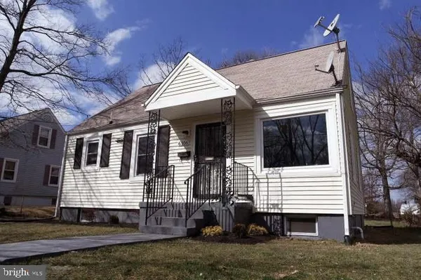 a view of a house with a yard and stairs