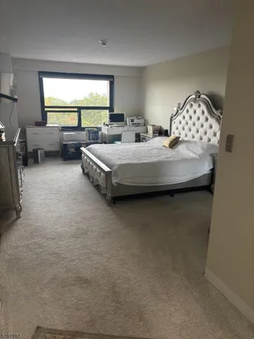 a bedroom with bed and window