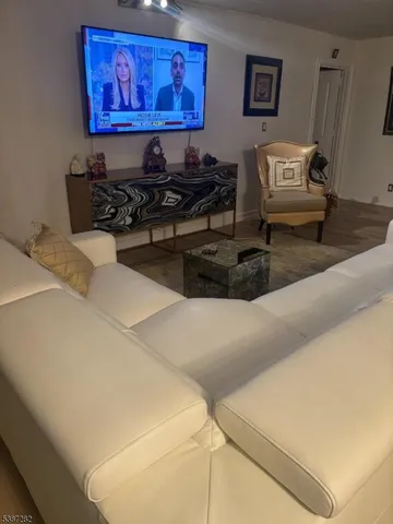 a living room with furniture and wall paintings