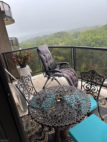 a view of a balcony with furniture and city view