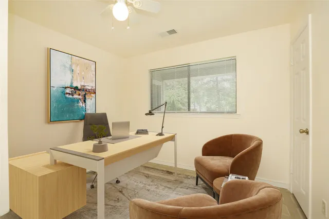 a work room with furniture and a window