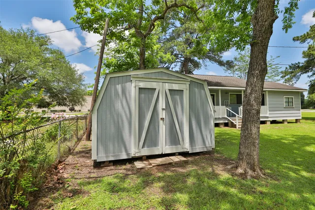 a view of backyard with small cabin