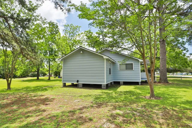 a backyard of a house with a garden and plants