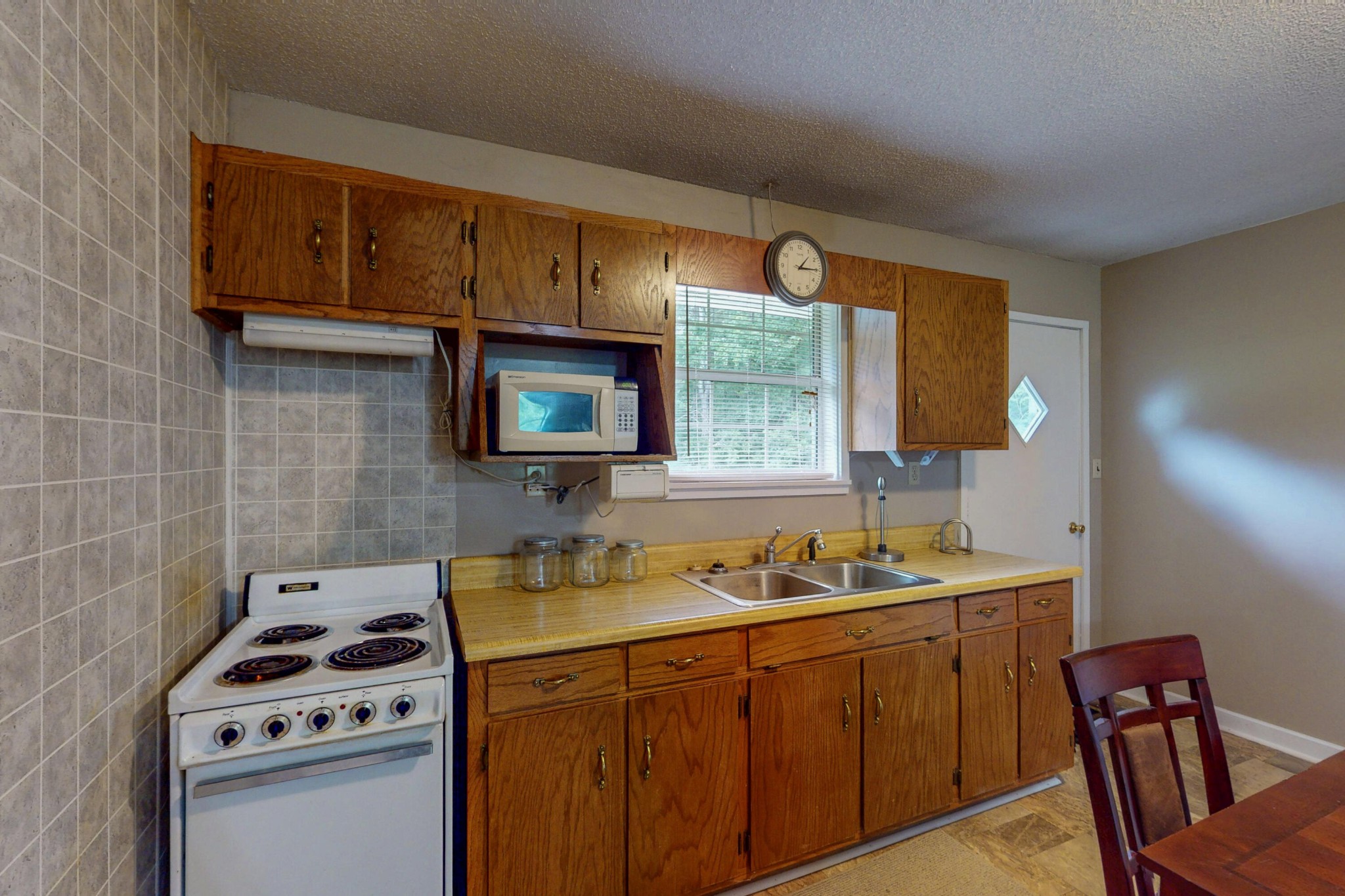 428 Caldwell Road Southeast Cleveland, TN 37323 - Photo 68 of 91 a kitchen with stainless steel appliances a stove a sink a microwave cabinets and a dining table