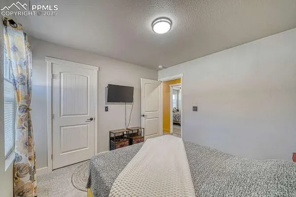 a bedroom with a bed and a chandelier