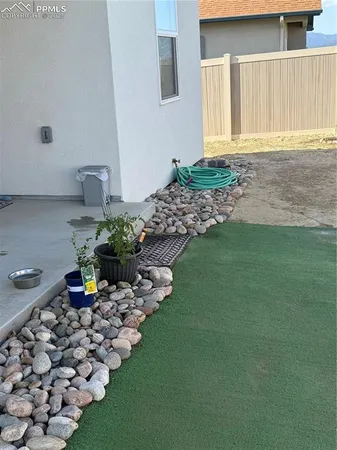 a view of a potted plant is sitting in front of a house