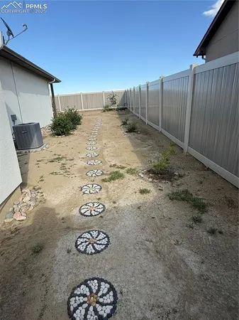 a view of a pathway with a flower plants