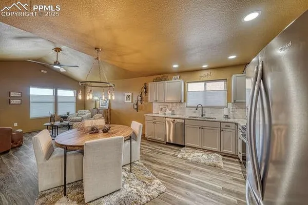 a large kitchen with kitchen island a sink stainless steel appliances and cabinets