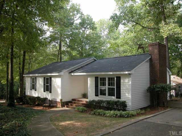 7201 Stuart Drive Raleigh, NC 27615 - Photo 1 of 9 a front view of a house with yard and green space
