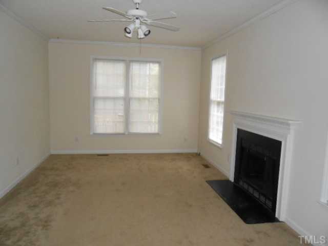 2409 Finley Ridge Lane Raleigh, NC 27615 - Photo 5 of 8 an empty room with chandelier fan and windows