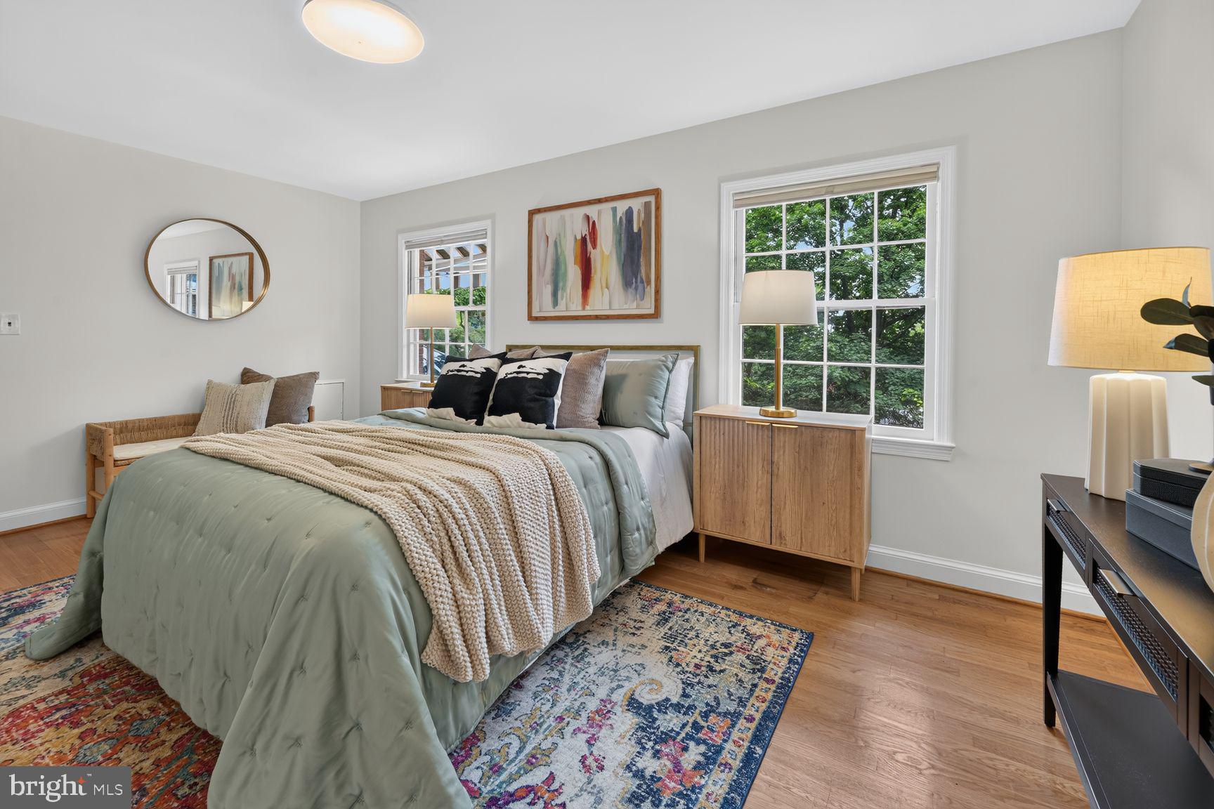 4605 Reno Road Northwest Washington, DC 20008 - Photo 25 of 49 a bedroom with a bed and a table in it next to a window