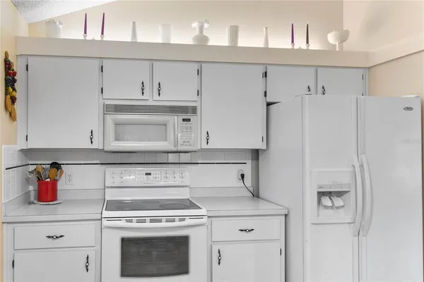 a kitchen with appliances cabinets and a counter top space
