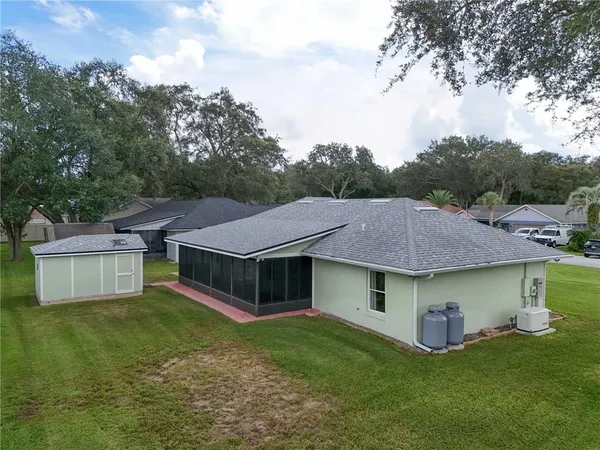 a aerial view of a house with swimming pool and a yard