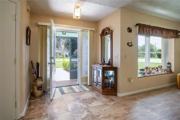 a view of an entryway and livingroom with furniture