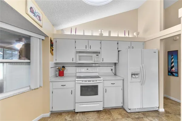 a kitchen with cabinets and appliances
