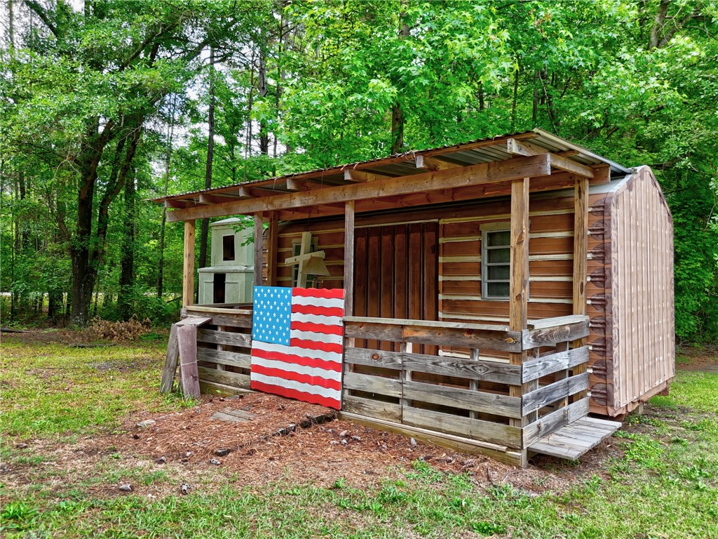 1016 Campbell Road Belton, SC 29627 - Photo 47 of 50 Quaint rustic outbuilding offers a private escape nestled amongst natural woodlands.