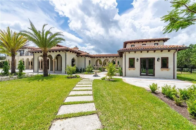 a kitchen with stainless steel appliances granite countertop a stove a sink dishwasher and a refrigerator with wooden floor