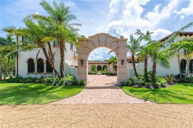 a large kitchen with stainless steel appliances granite countertop a large center island a stove and a view of living room
