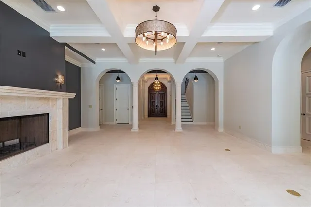 a view of an empty room with wooden floor and white walls