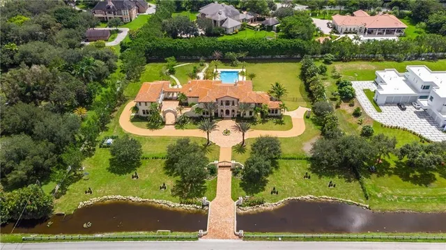 a front view of a house with a garden and plants