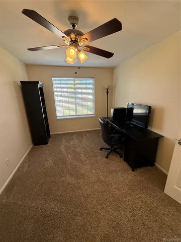 a living room with furniture and a piano