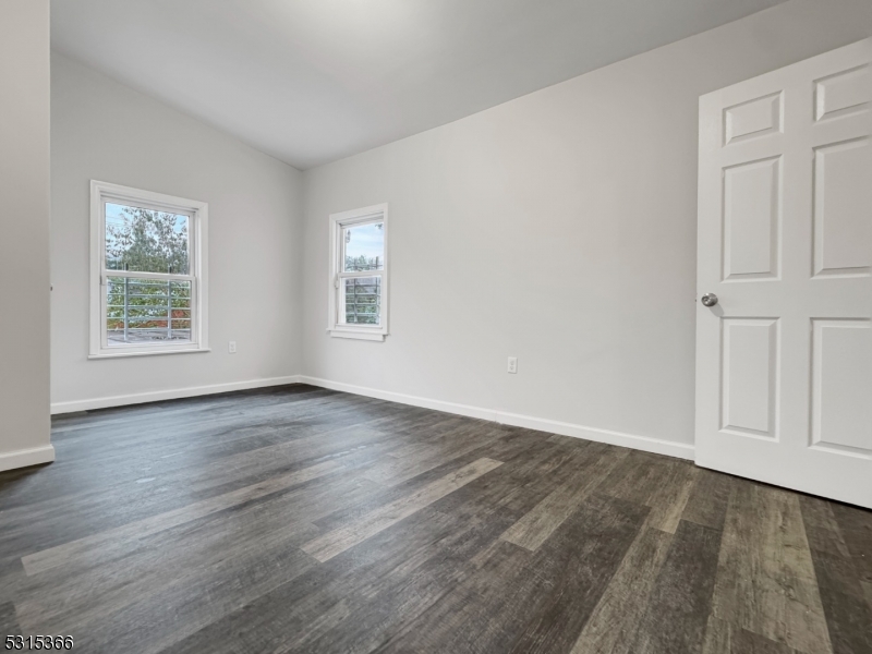 511 South Main Street, Unit 2 Phillipsburg, NJ 08865 - Photo 5 of 10 an empty room with wooden floor and windows