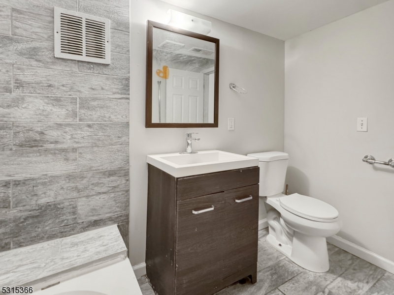 511 South Main Street, Unit 2 Phillipsburg, NJ 08865 - Photo 8 of 10 a bathroom with a sink toilet and mirror