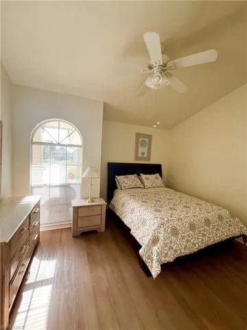 a bedroom with a bed and a large window