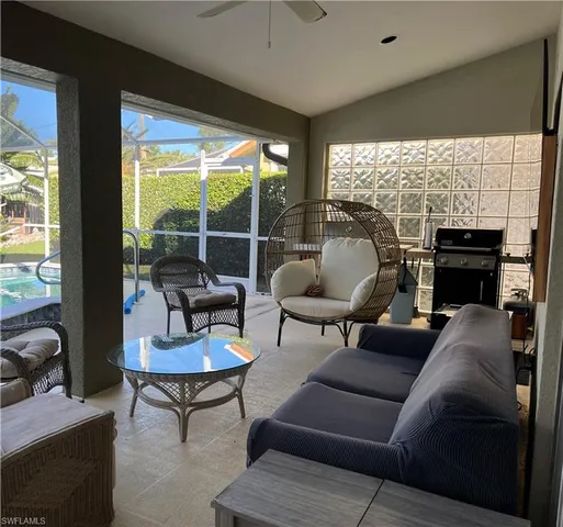 a living room with furniture and a floor to ceiling window