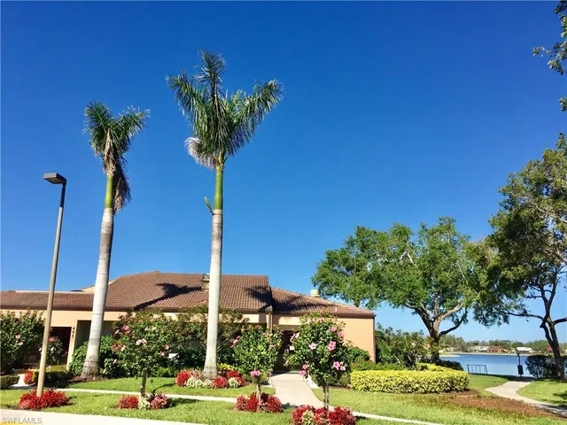 a view of a house with a yard and tree s