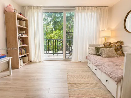 a spacious bedroom with a bed and a window