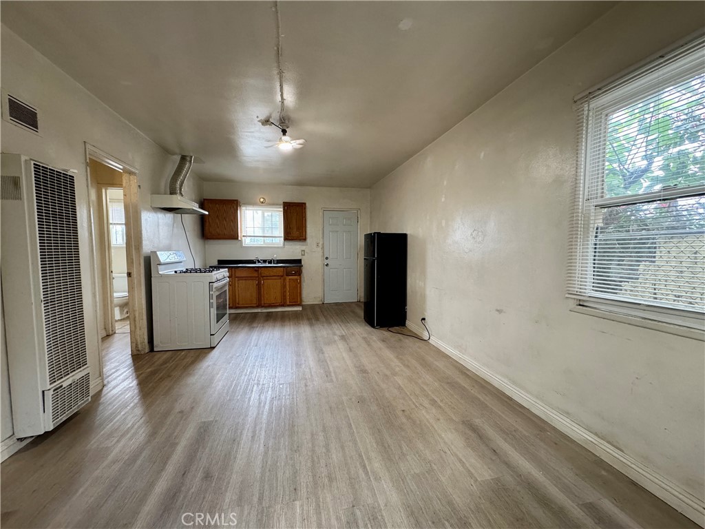 a kitchen with a refrigerator and a stove top oven
