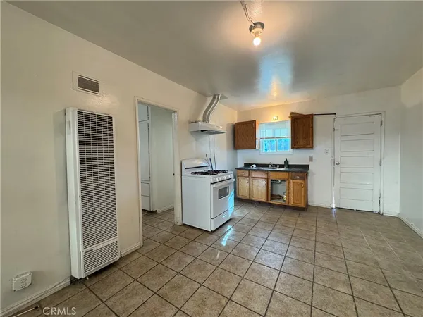 a kitchen with a sink a stove and cabinets