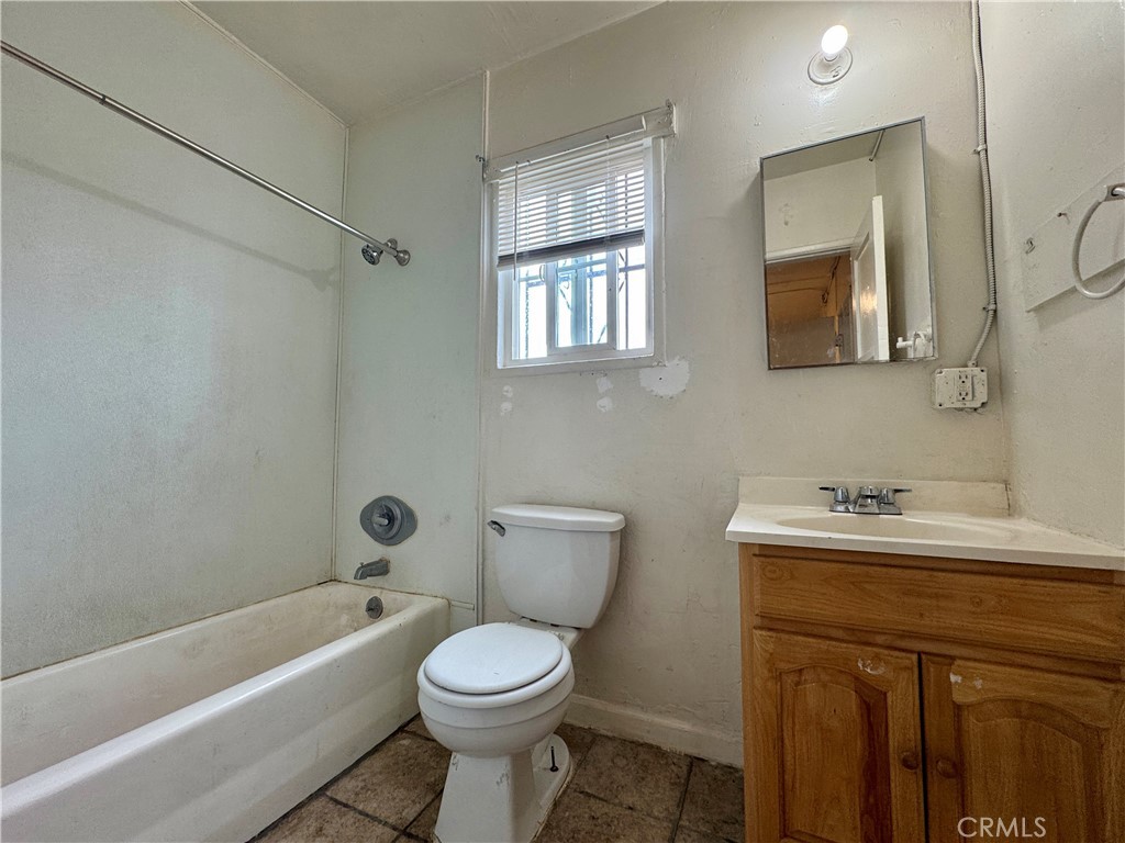 12616 Lambert Road, Unit 5 Whittier, CA 90602 - Photo 3 of 7 a bathroom with a sink a toilet and a bathtub