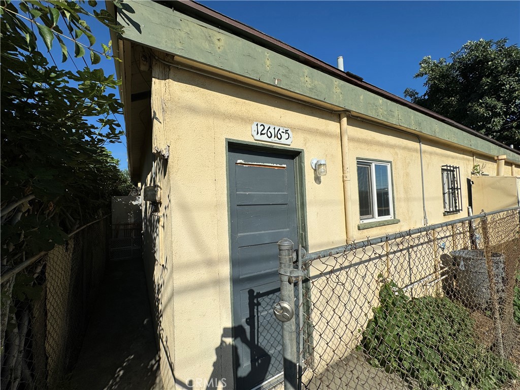 12616 Lambert Road, Unit 5 Whittier, CA 90602 - Photo 4 of 5 a front view of a house with a yard