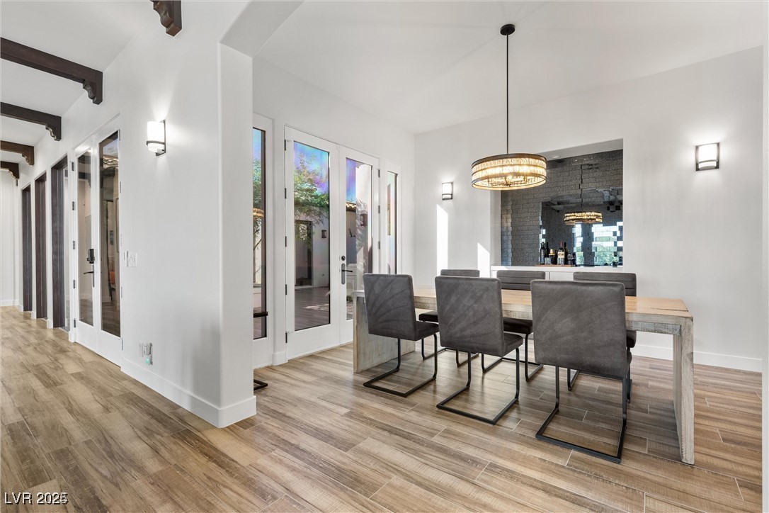 3 Rue Allard Way Henderson, NV 89011 - Photo 16 of 49 Dining area featuring light wood-style floors, beam ceiling, and french doors