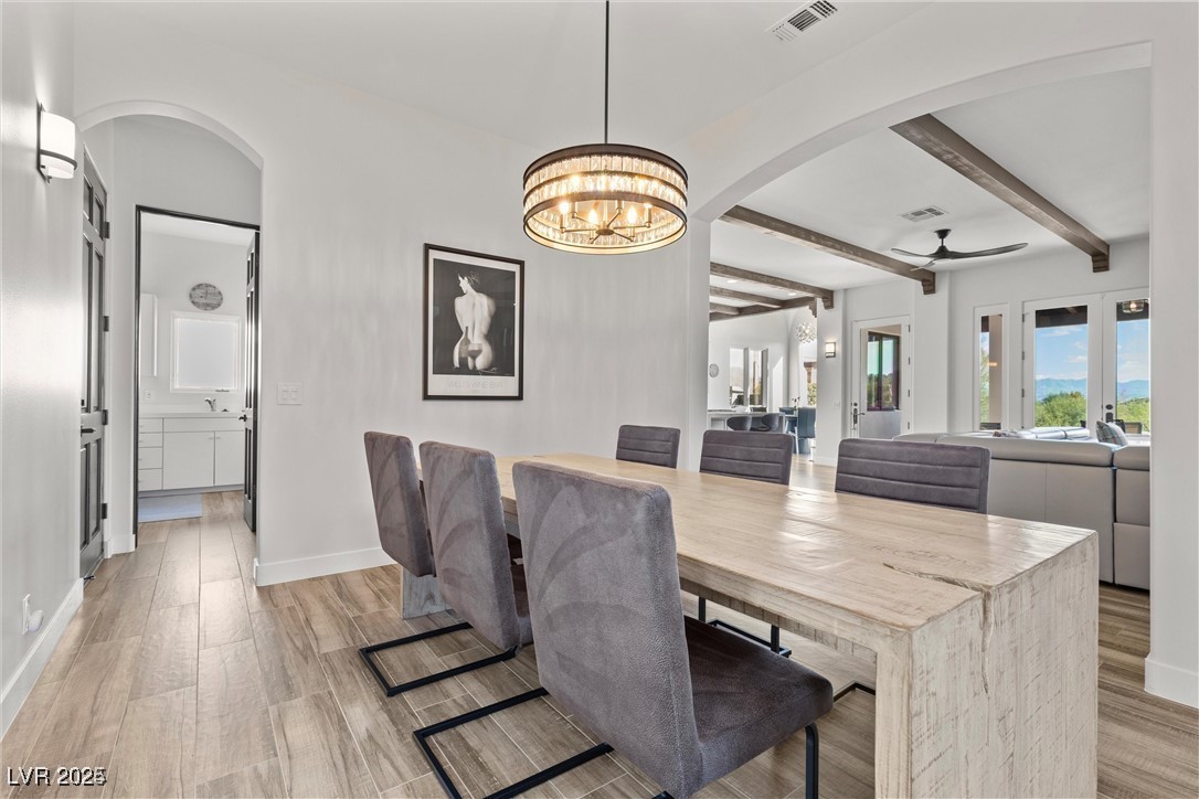 3 Rue Allard Way Henderson, NV 89011 - Photo 17 of 49 Dining room featuring light wood-type flooring, baseboards, visible vents, and beamed ceiling